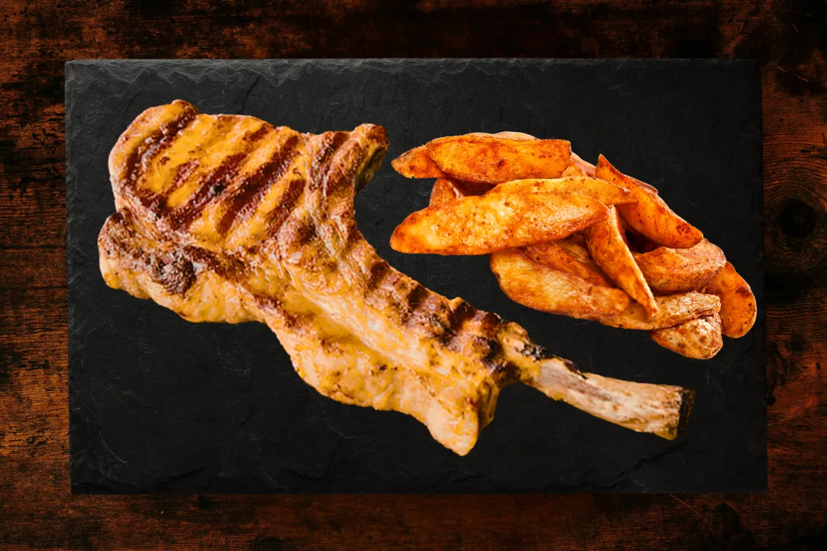 Grilled Greek cutlet with side of potato wedges
